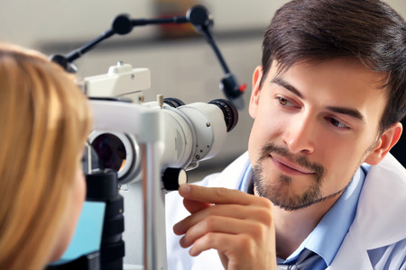 Adult male doctor examing adult female patient