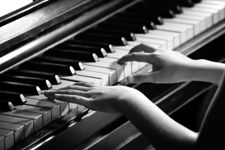 Close up of little girl hands piano playingの写真素材