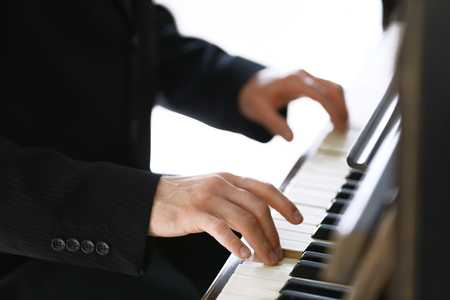 Close up of man hands piano playingの写真素材