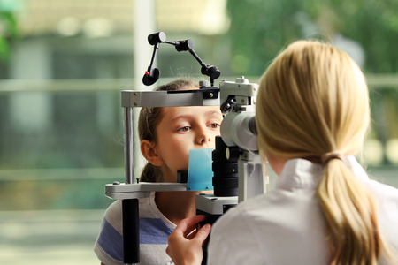 Adult female doctor examing small girl patientの写真素材