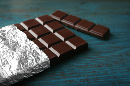 Dark Chocolate bar in foil  on gray backgroundの写真素材