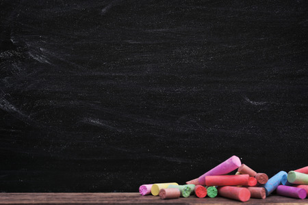 Multicoloured chalk on blackboard backgroundの写真素材