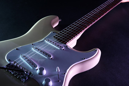 Electric guitar, on dark lighted backgroundの写真素材