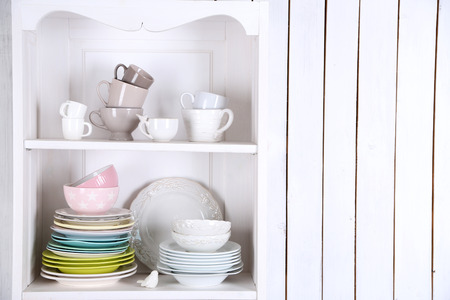 Different clean dishes on wooden shelvesの写真素材