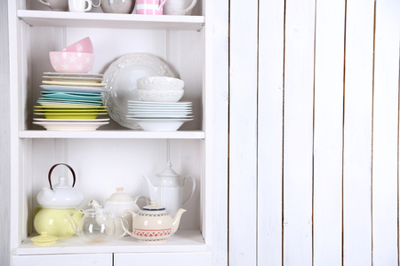 Different clean dishes on wooden shelvesの写真素材