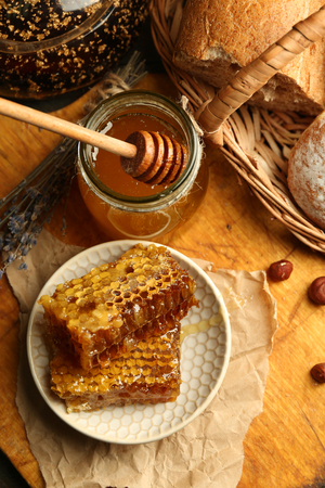Honeycombs on plate, hot buns on wooden backgroundの写真素材