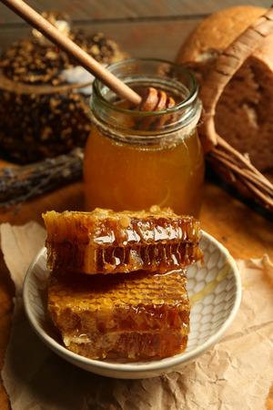 Honeycombs on plate, hot buns on wooden backgroundの写真素材