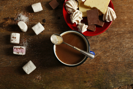 Cup of coffee with sweets on wooden backgroundの写真素材