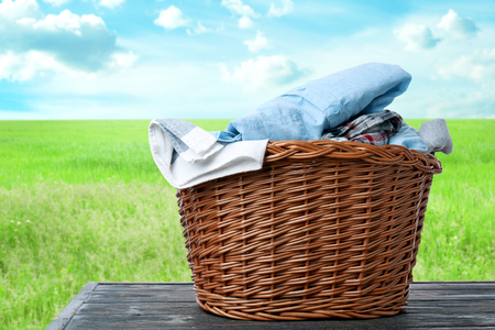 Basket with laundry on table outdoorsの写真素材