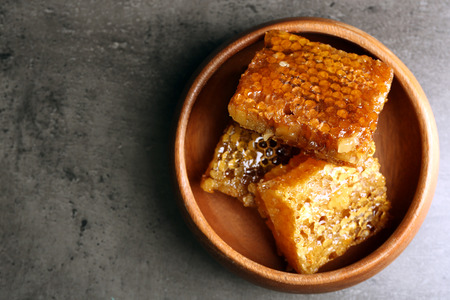 Honeycombs on plate on gray background