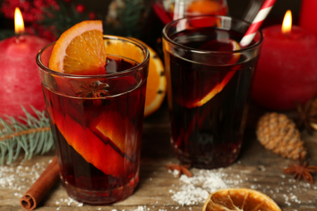 Decorated composition of mulled wine in glasses on wooden table, close upの写真素材