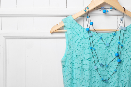 Dress and necklace on hanger on wall backgroundの写真素材