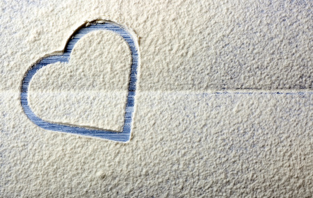 Heart of flour on wooden backgroundの写真素材