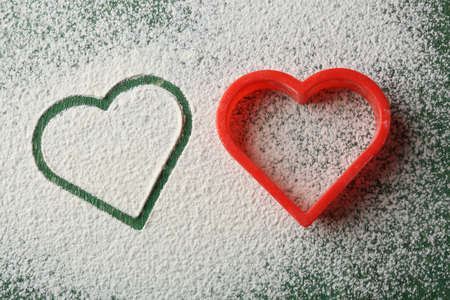 Heart of flour on wooden backgroundの写真素材