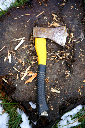 Used ax with plastic handle on wooden backgroundの写真素材