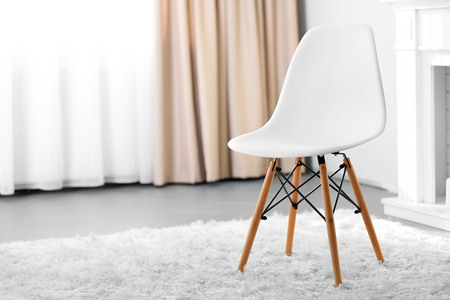 Stylish conception with white chair on light room backgroundの写真素材