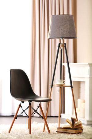 Stylish conception with chair and lamp on light room backgroundの写真素材