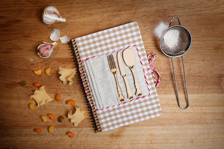 Decorated cookbook on wooden backgroundの写真素材