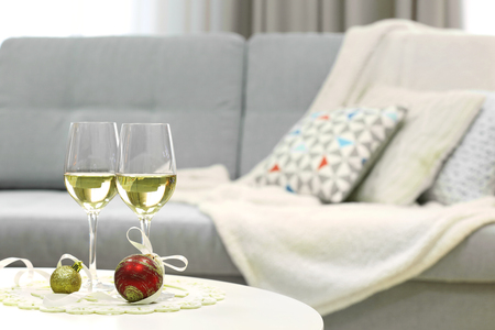 Two champagne glasses with Christmas decor on home interior backgroundの写真素材