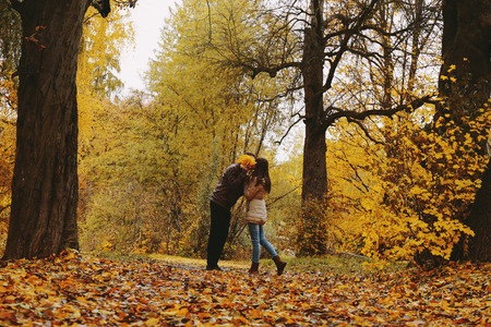 Couple kissing in the autumn parkの写真素材
