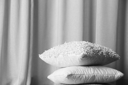 Multicoloured pillows on a curtain backgroundの写真素材