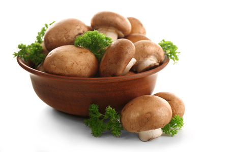 Mushrooms in bowl, isolated on whiteの写真素材