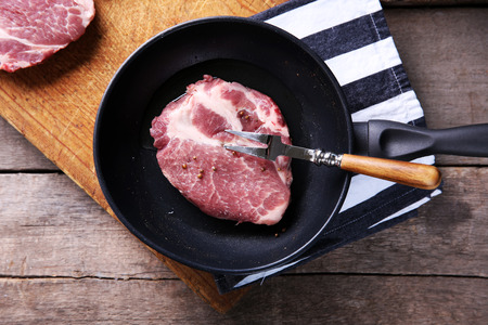 Marbled beef steak and spices on wooden backgroundの写真素材