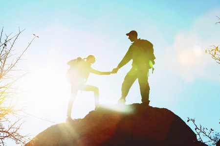 Man and woman climbing the mountainの写真素材