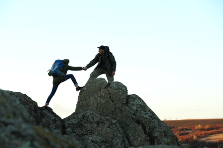 Man and woman climbing the mountainの写真素材
