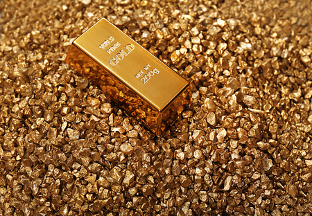 Gold bars on nugget grains background, close-upの写真素材