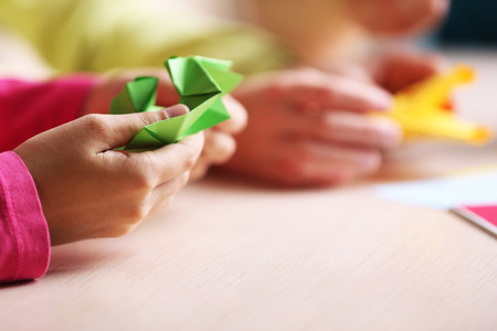 Children making swan with coloured paperの写真素材