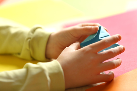 Children making swan with coloured paperの写真素材