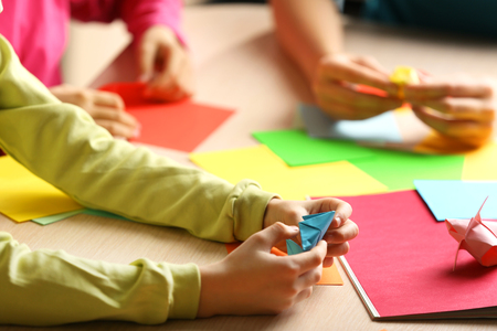 Children making swan with coloured paperの写真素材