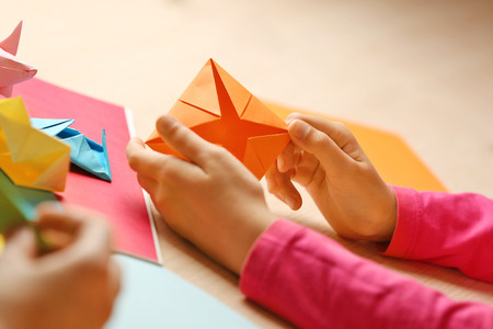 Children making swan with coloured paperの写真素材
