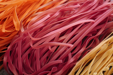 Uncooked pasta as background, closeupの写真素材