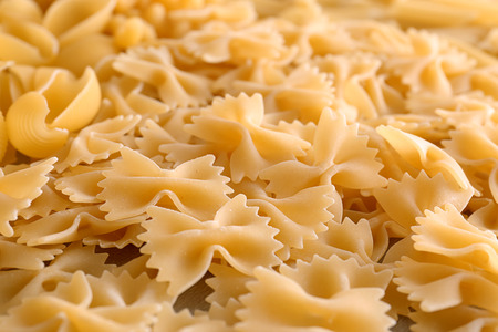 Uncooked pasta as background, closeupの写真素材