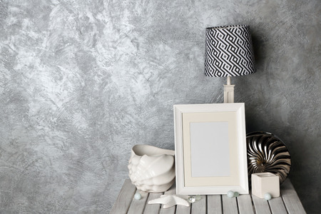 Home decor on table on grey wall background