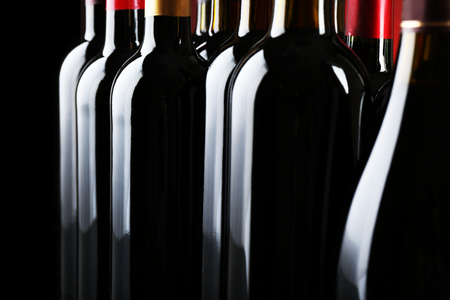 Wine bottles on dark background, close upの写真素材