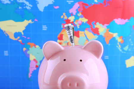 Money box pig on world map backgroundの写真素材