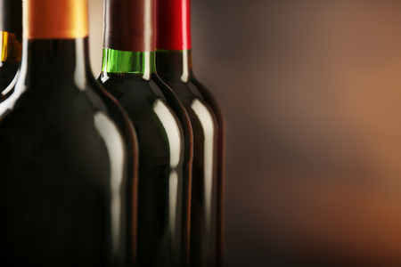 Wine bottles on wooden background, close upの写真素材