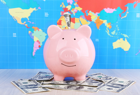 Money box pig on world map backgroundの写真素材