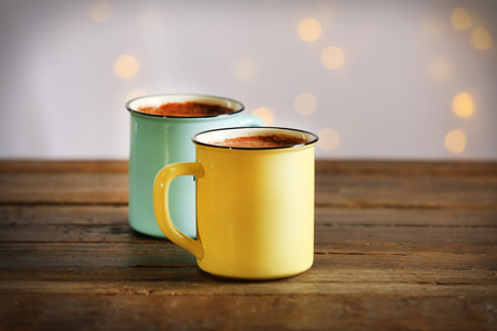 Tasty cocoa in metal old-fashioned mugs on the tableの写真素材