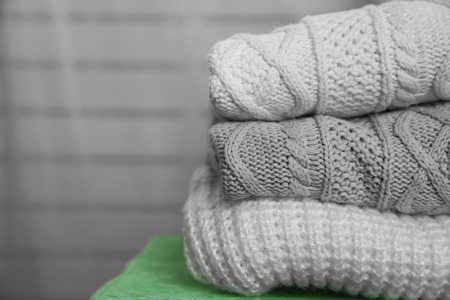 Knitted clothes on a sofaの写真素材