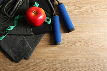 Sport shoes, clothes, equipment and smart phone with headphones on light backgroundの写真素材