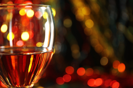A glass of pink wine on blurred lighted backgroundの写真素材