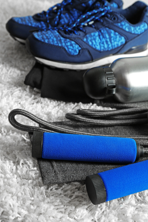 Sport clothes and equipment on white carpet backgroundの写真素材