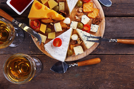 Cheese for tasting on wooden background, top viewの写真素材