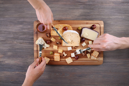 Different kinds of cheese on wooden backgroundの写真素材