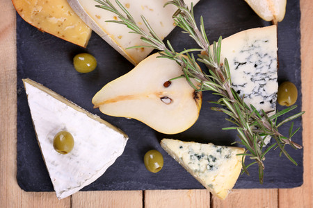 Different kinds of cheese on wooden backgroundの写真素材