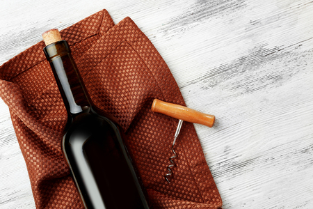 Wine with corkscrew on a light wooden backgroundの写真素材